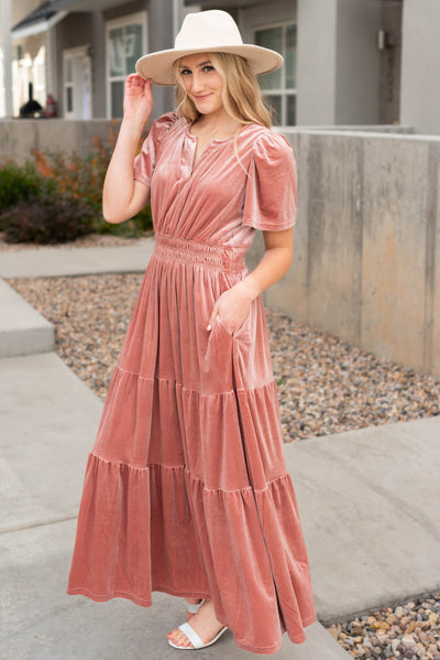 Front view of the velvet blush dress with pockets