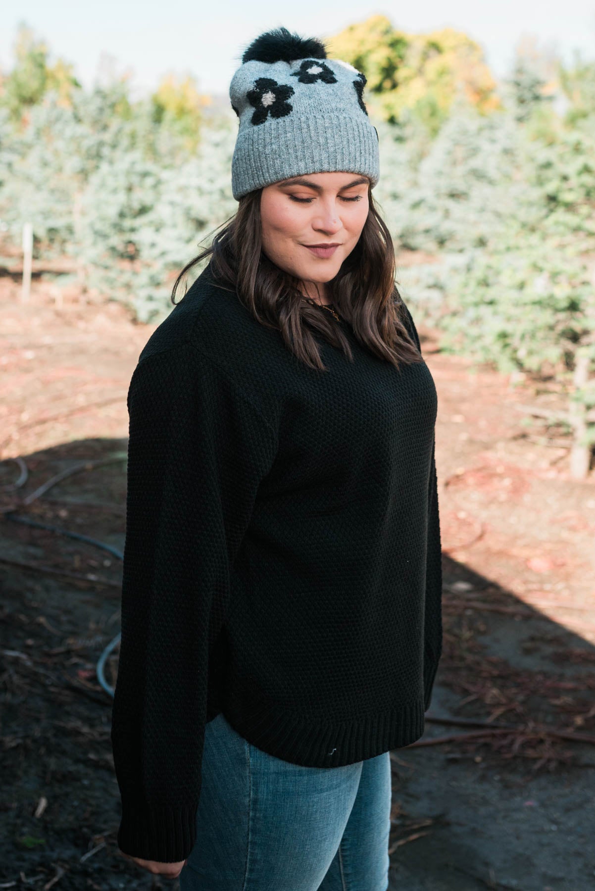 Side view of the plus size black sweater