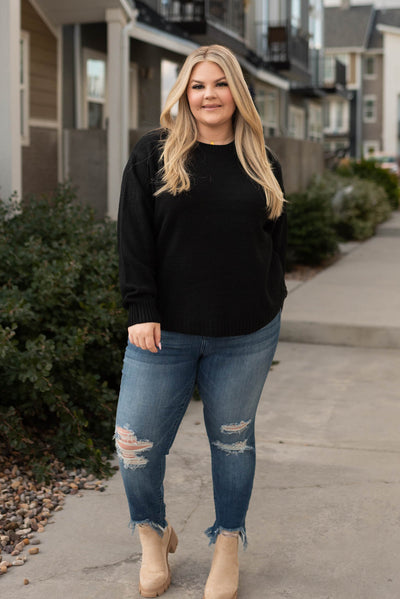 Front view of a plus size long sleeve black sweater