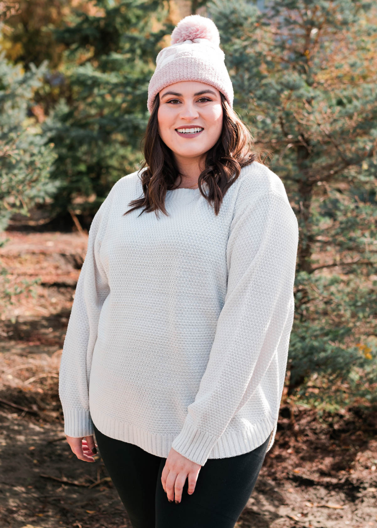Front view of a plus size bone sweater