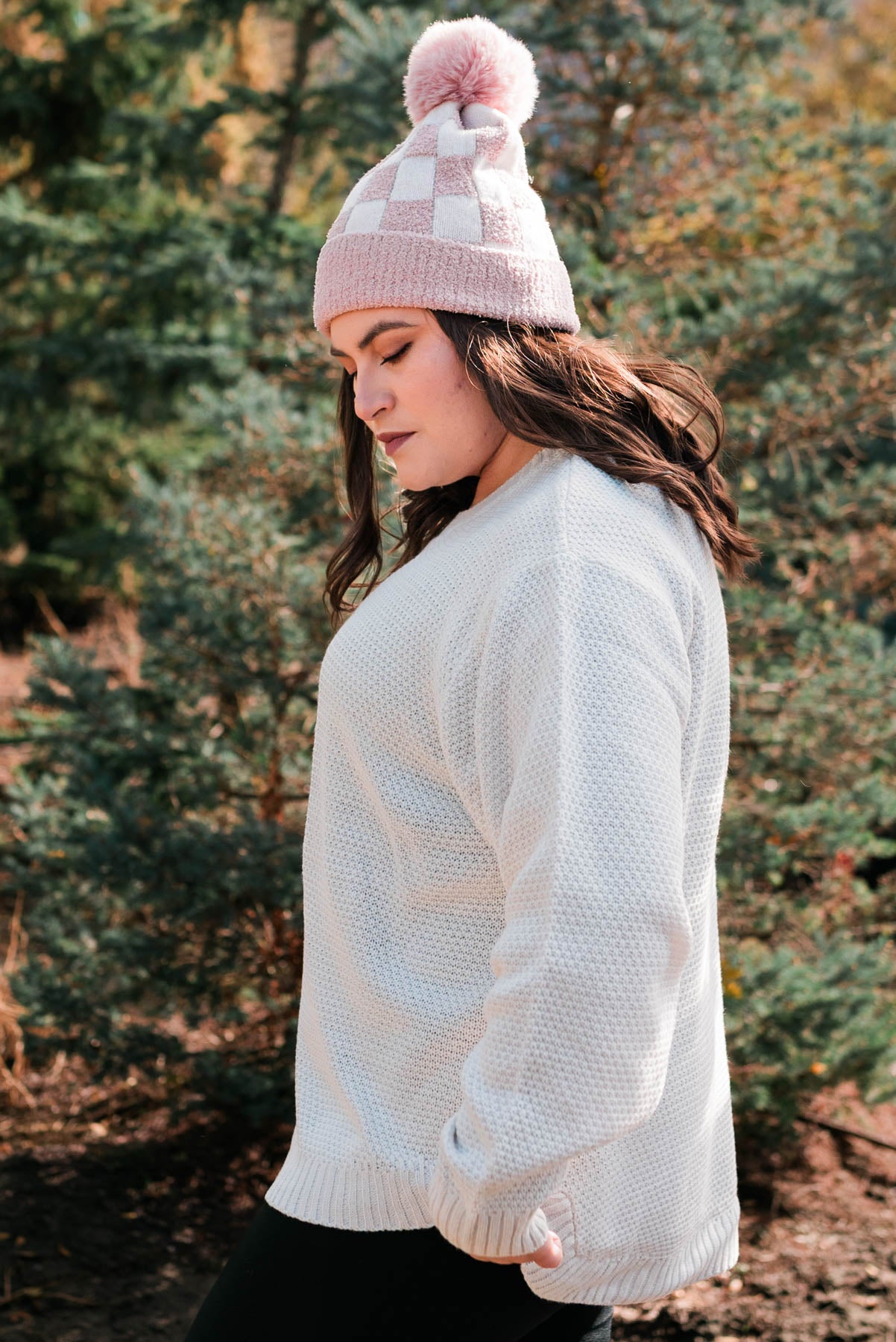 Side view of a plus size bone sweater