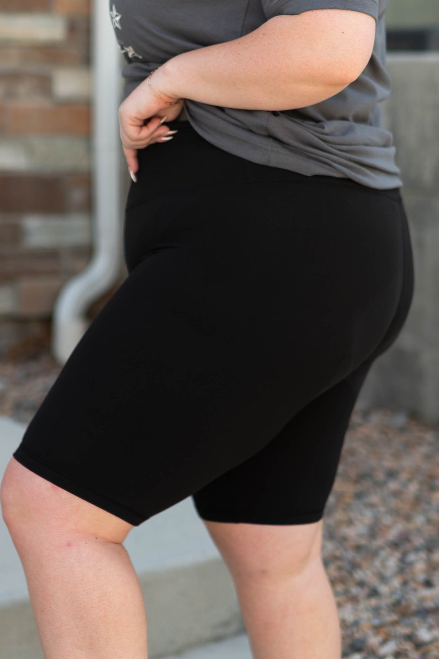 Side view of black plus size biker shorts