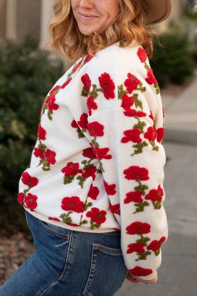 Side view of a fleece flowered sweater