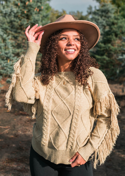 Sage knit sweater with fringe along the arm