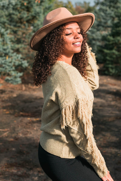 Side view of a sage knit sweater
