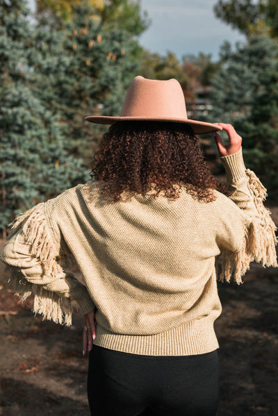 Back view of a fringed sage knit sweater