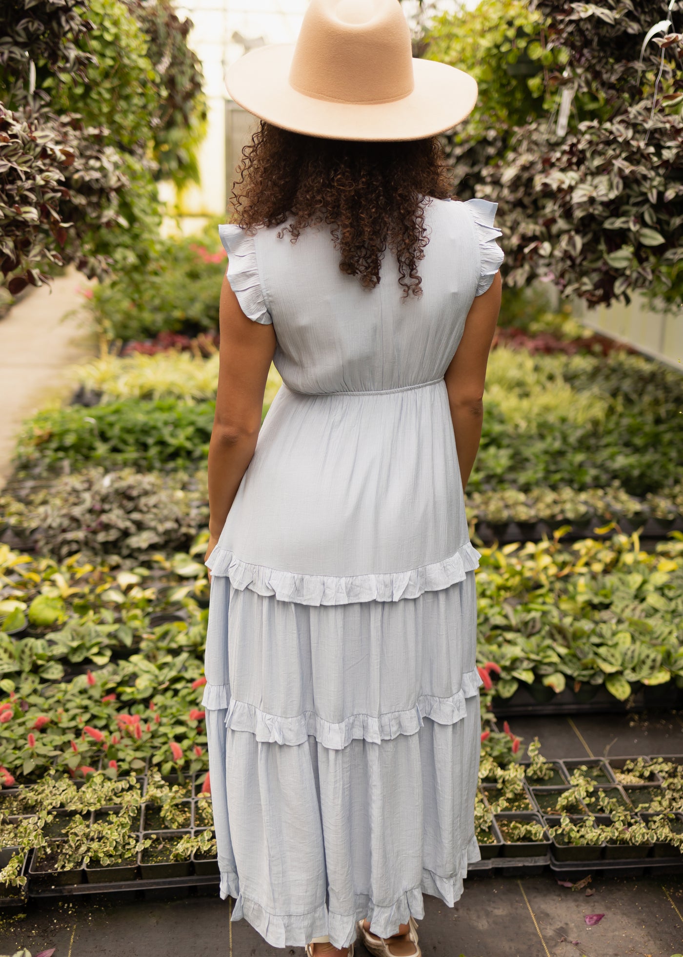 Back view of a baby blue dress with ruffles on the bodice