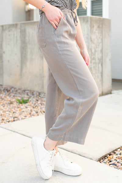 Side view of the grey drawstring wide leg pants