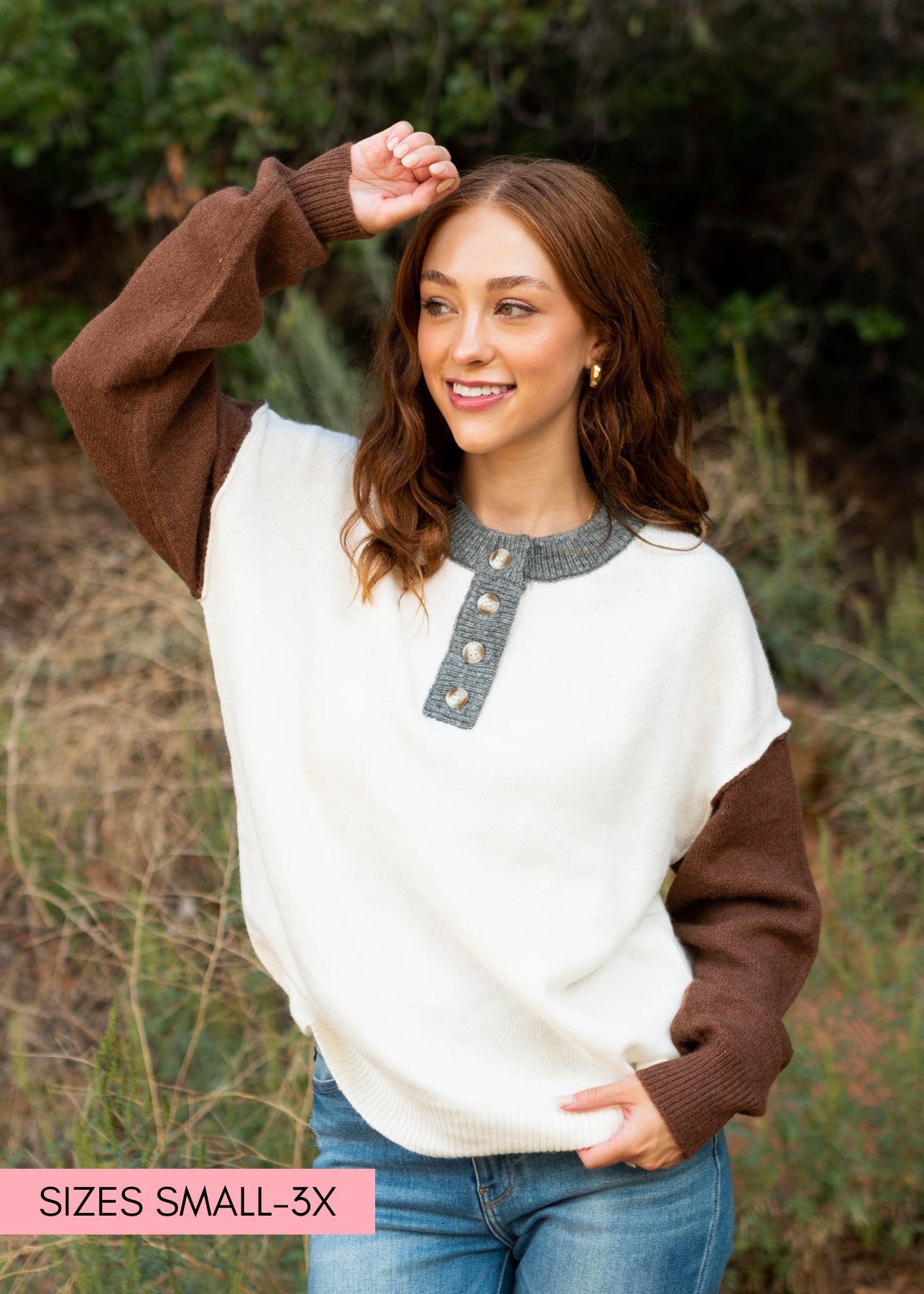 Long sleeve oatmeal sweater with grey trim and buttons at the neck