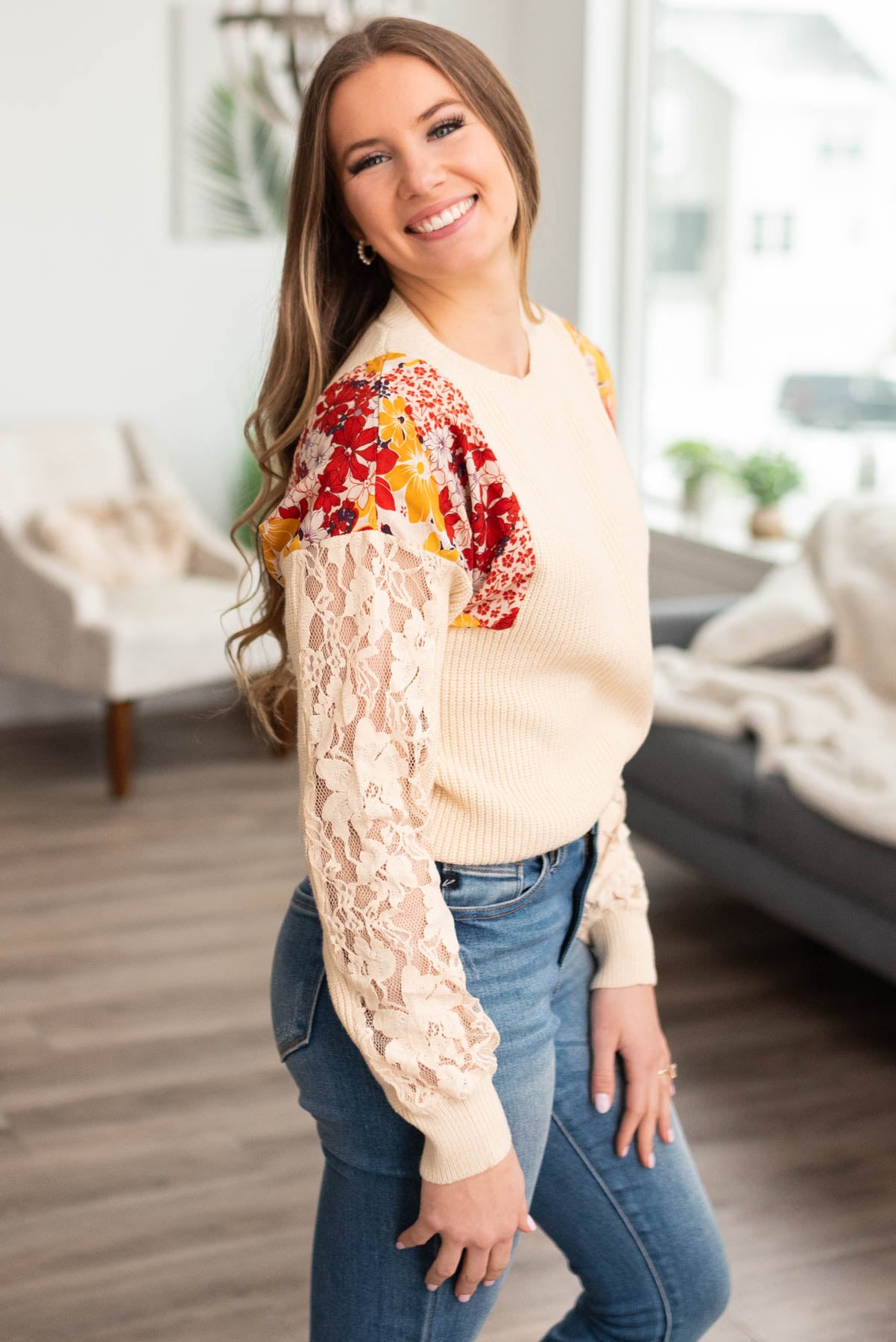 Side view of an ivory floral sweater