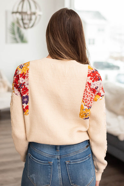 Back view of the ivory floral sweater