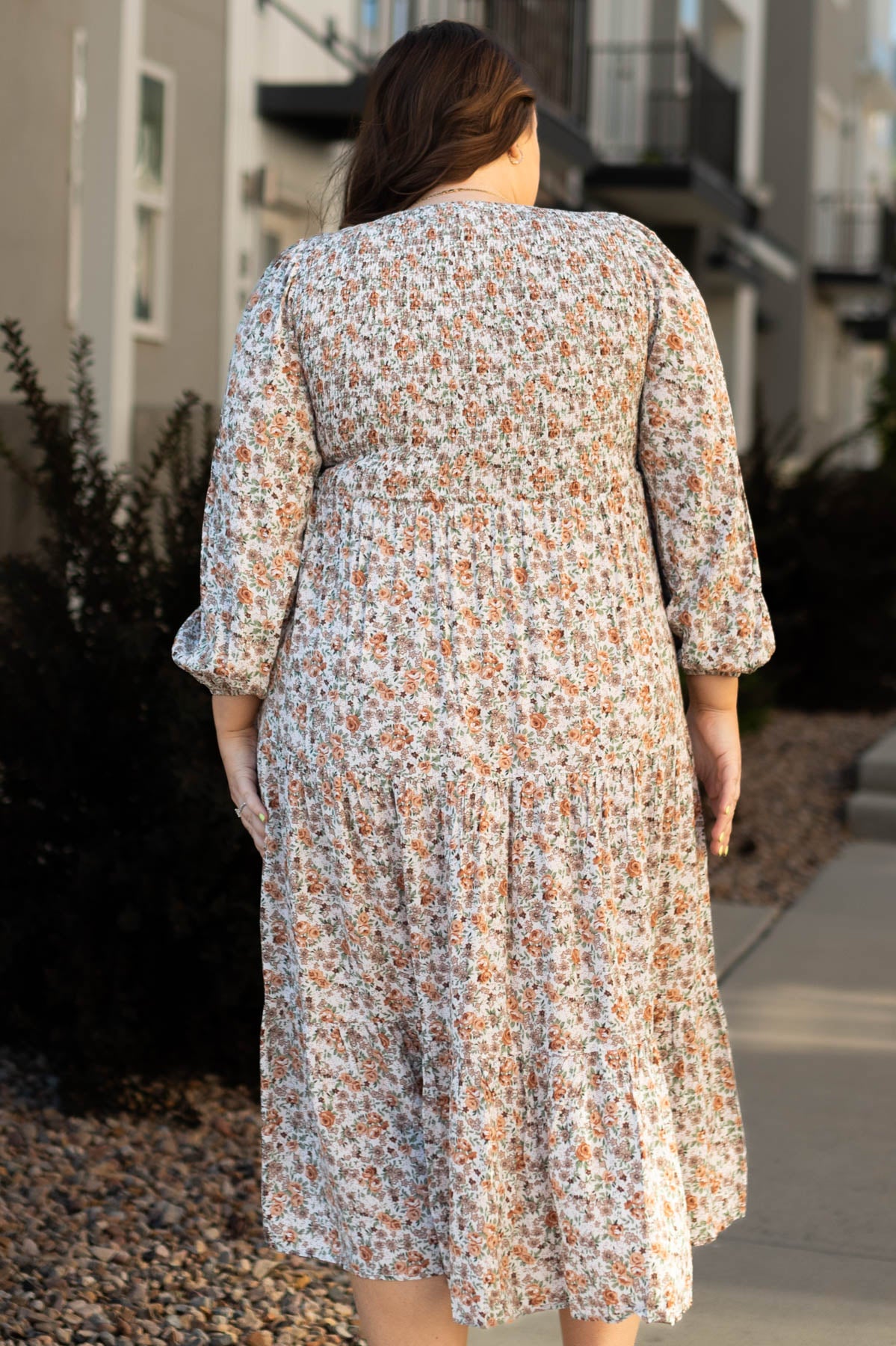 Back view of a plus size taupe floral dress