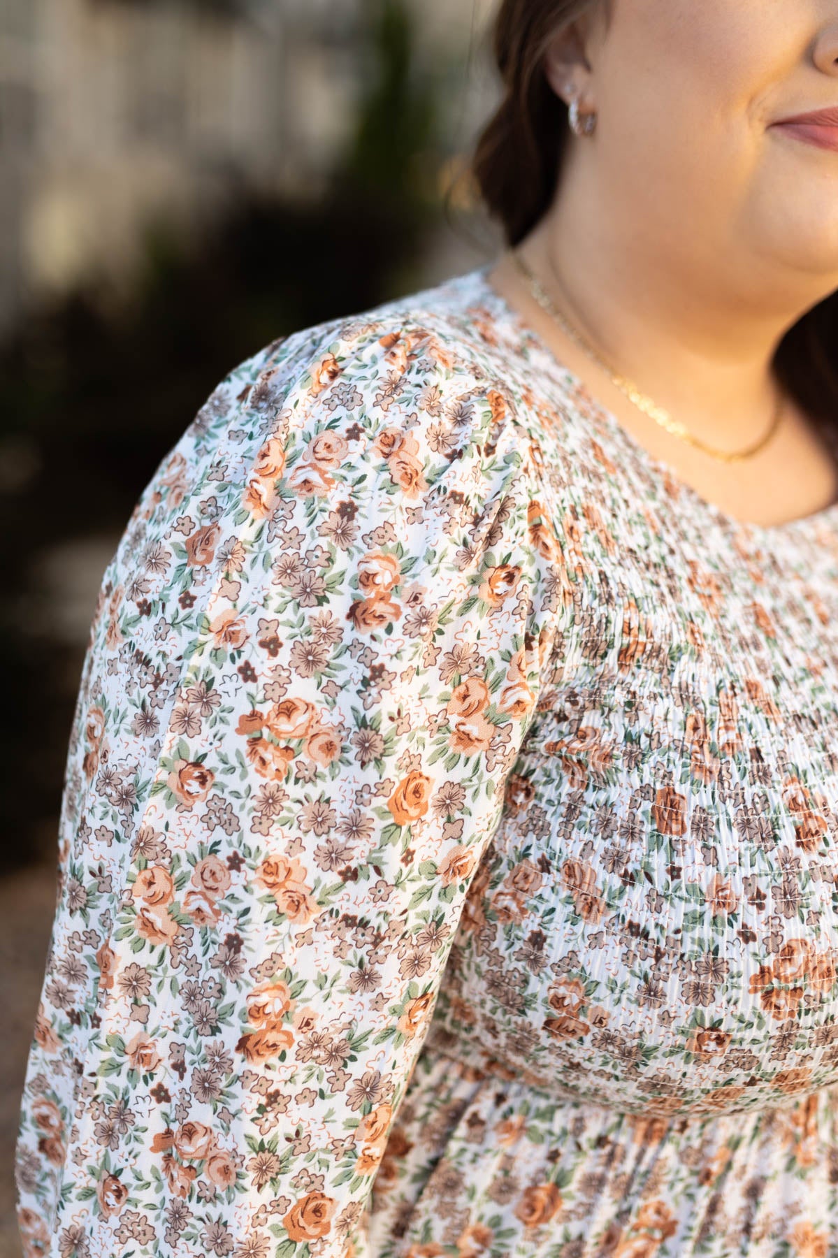 Close up of the floral print on a plus size taupe floral dress