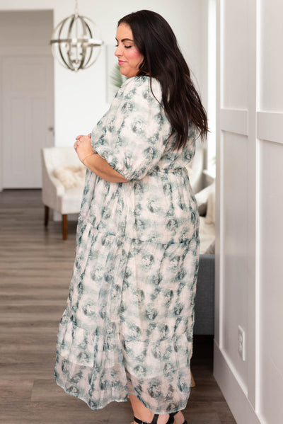 Side view of a plus size green floral dress