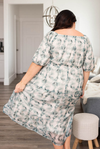 Back view of a plus size green floral dress