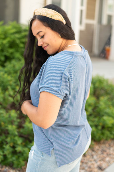 Side view of a denim blue top