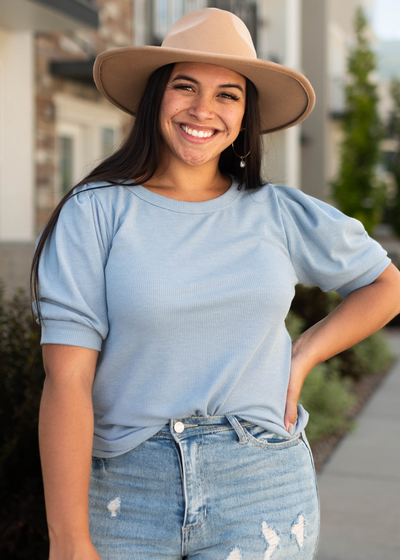 Denim blue top with cuffs on short sleeves and round neck