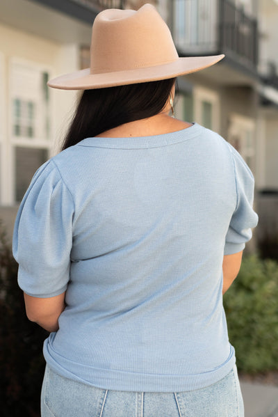 Back view of a denim blue top