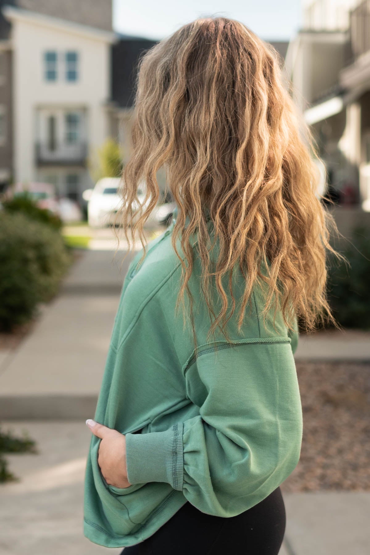 Side view of a dark sage pullover