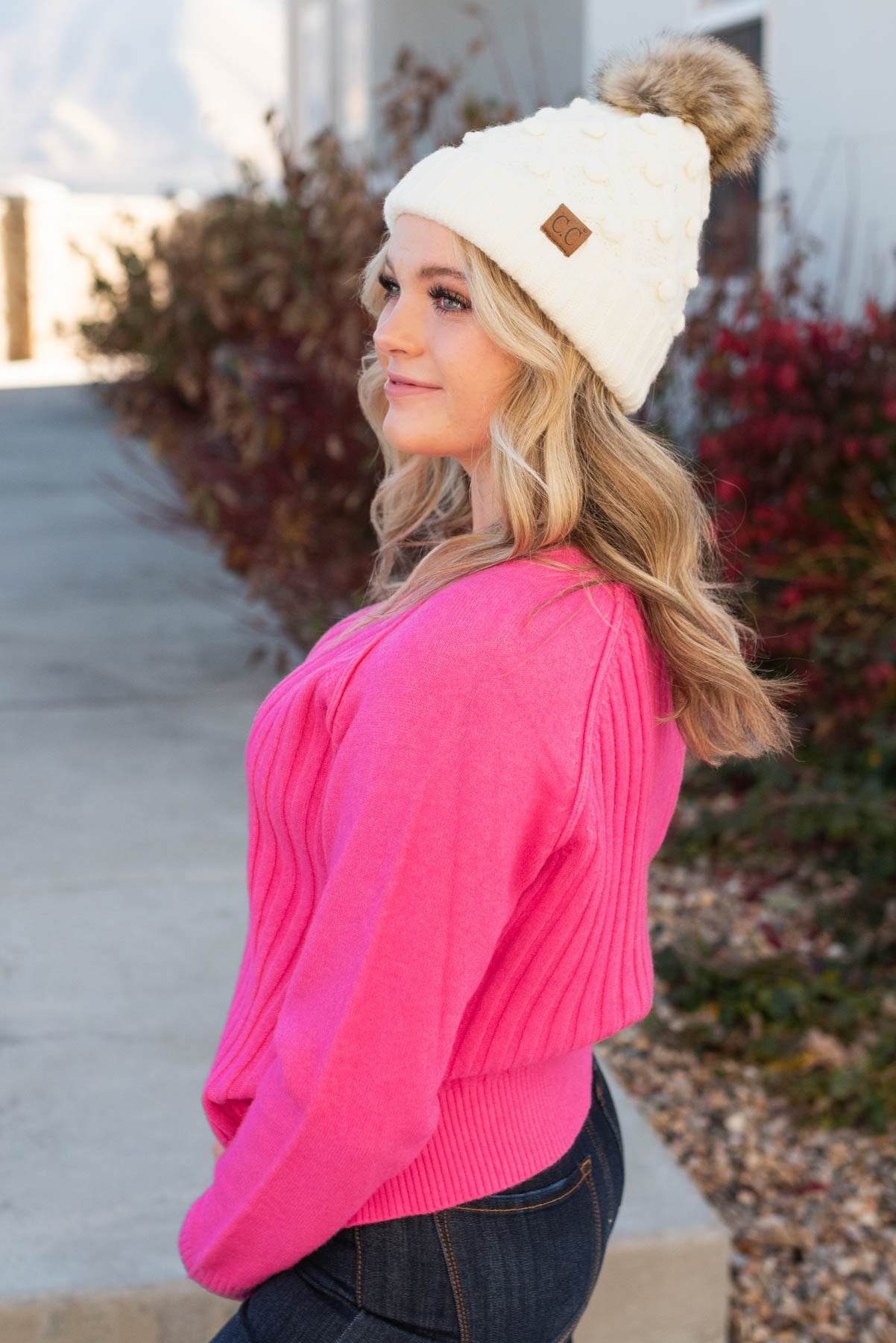 Side view of a hot pink sweater