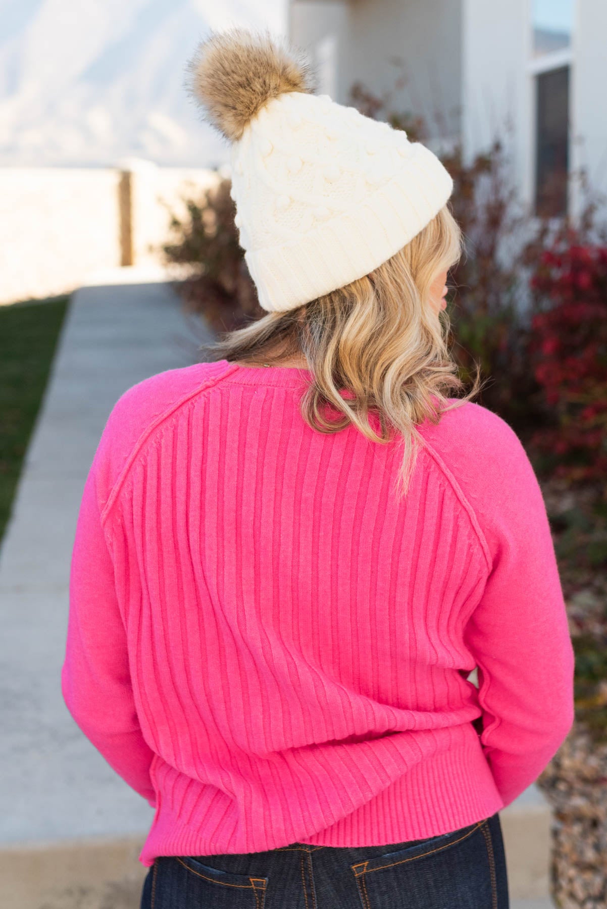 Back view of a hot pink sweater