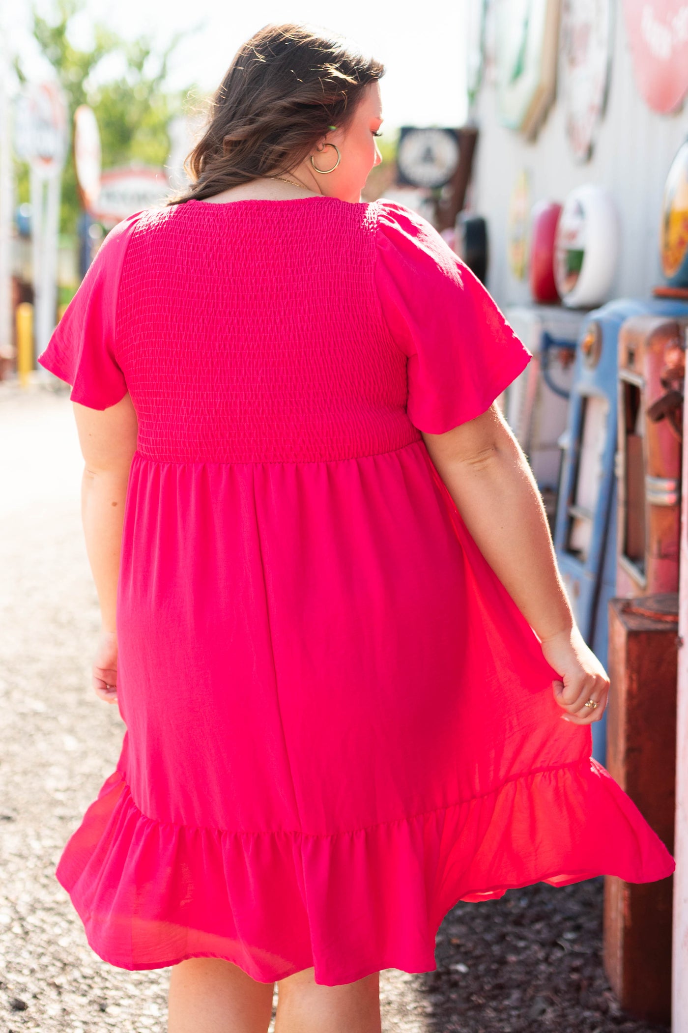 Back view of a plus size short sleeve fuchsia dress with a smocked bodice.