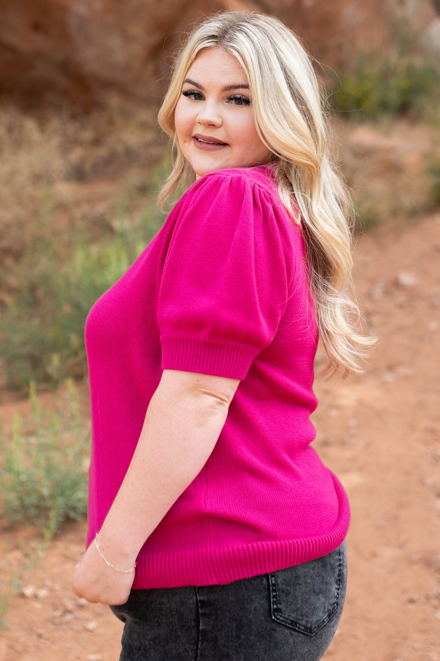 Side view of a plus size fuchsia top