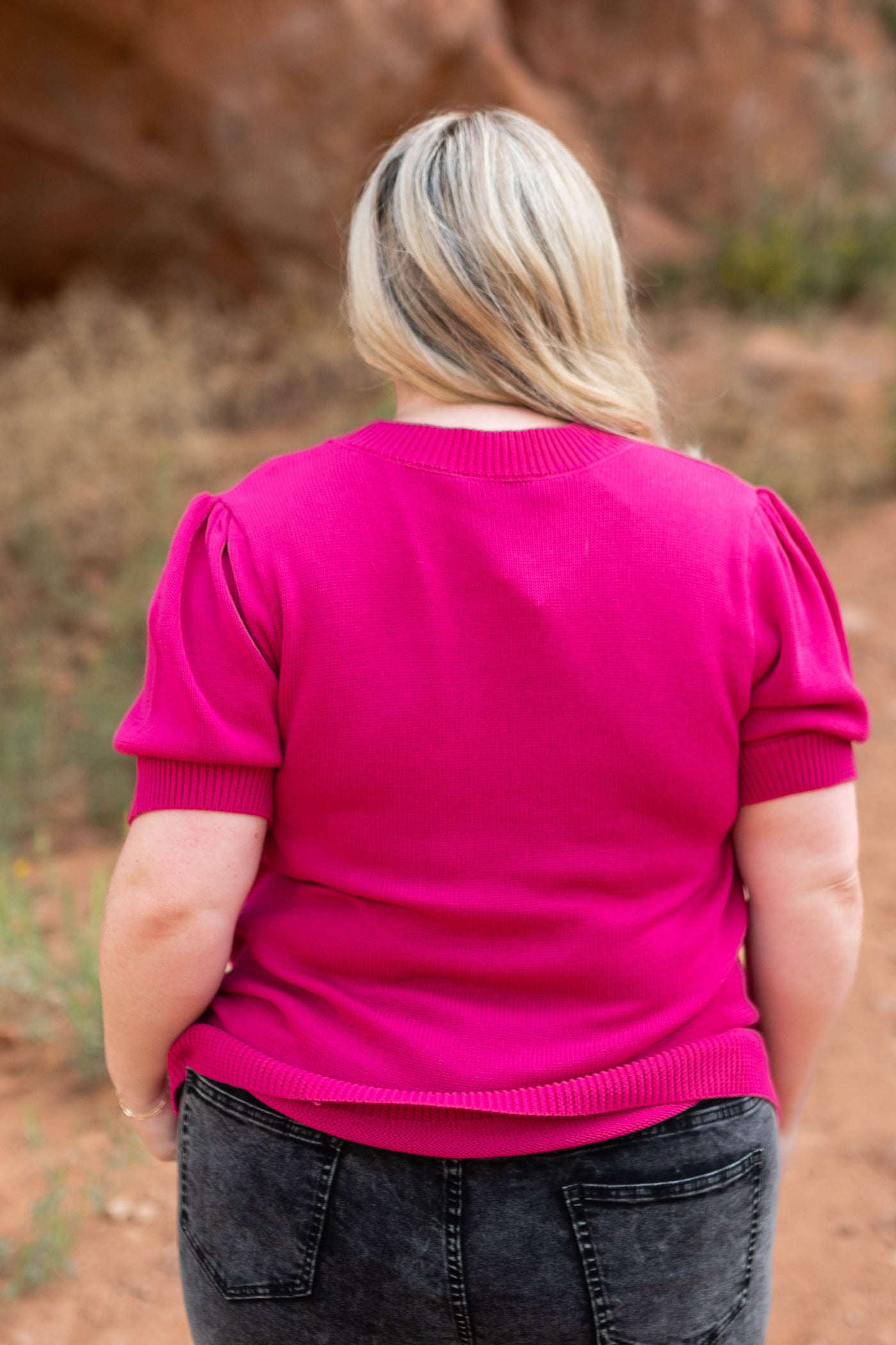 Back view of a plus size fuchsia top