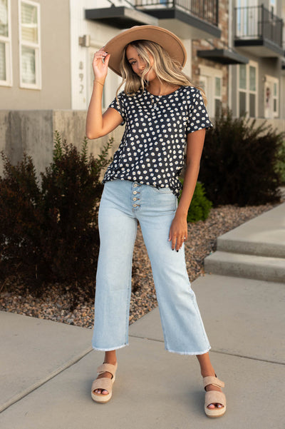 Black floral top with light wide leg jeans that are sold separately