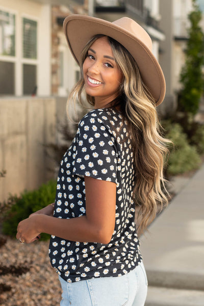 Side view of a black floral top
