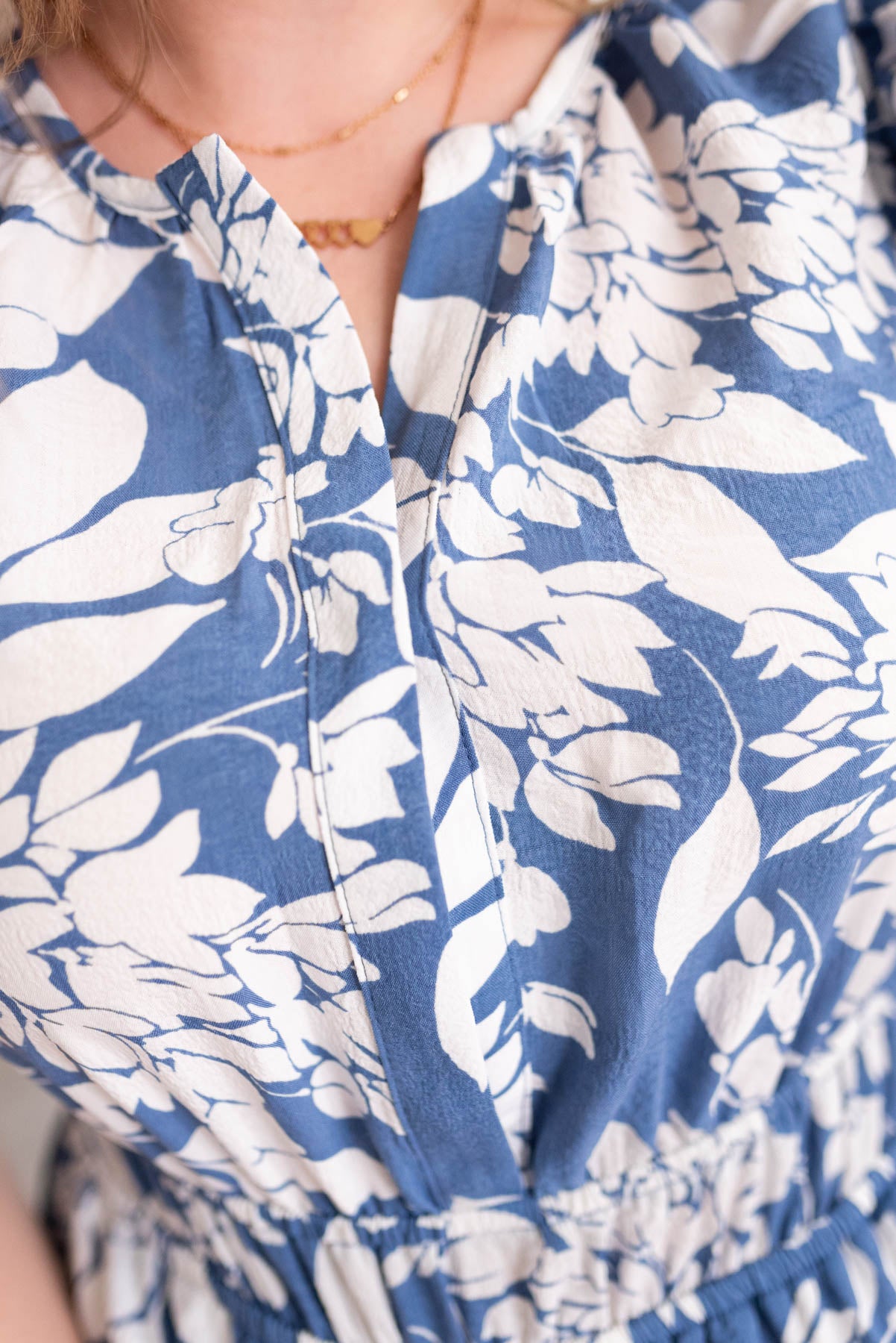 Close up of the neckline on the blue floral dress