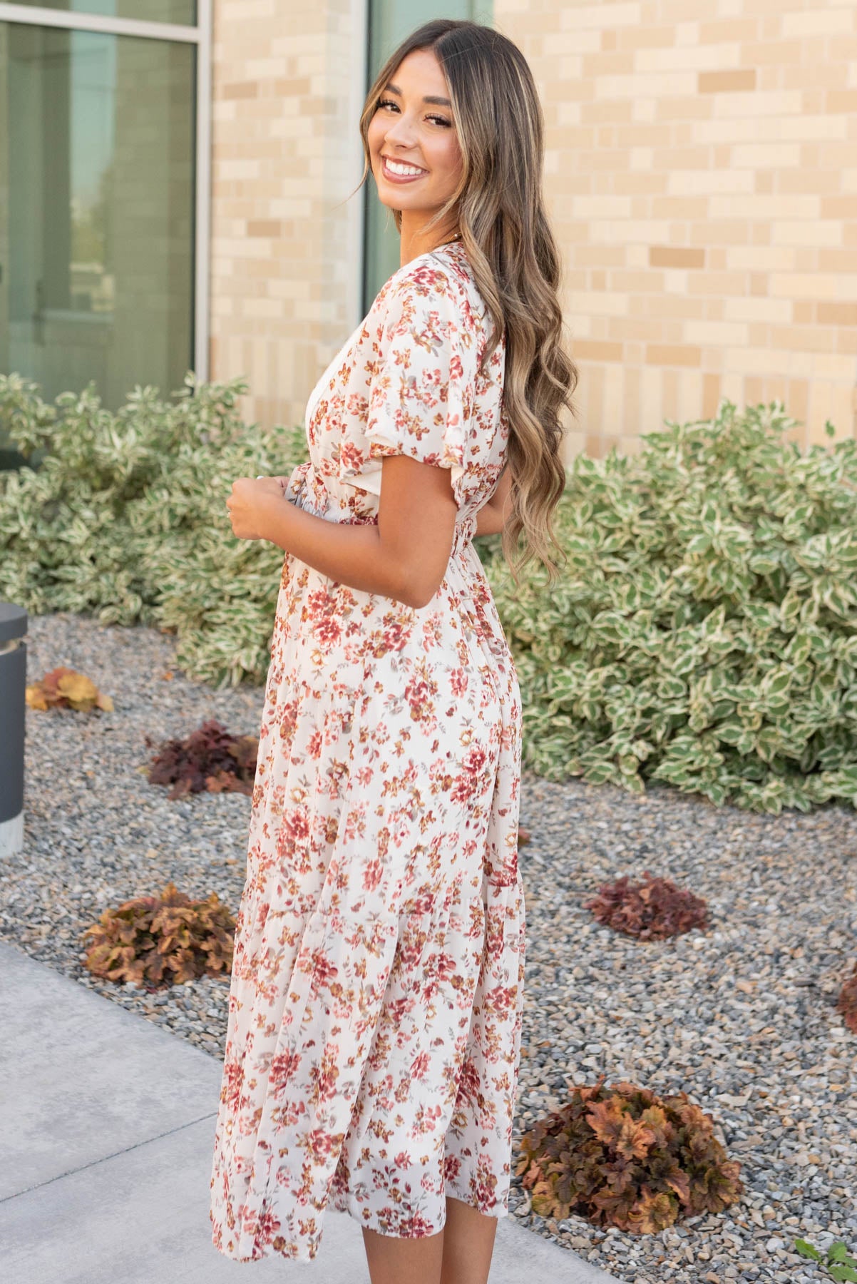Side view of the cream floral tiered dress