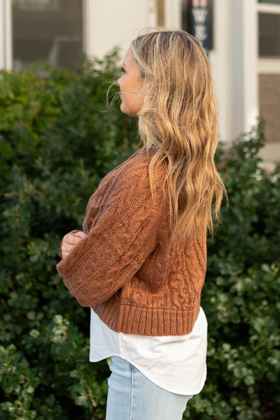 Side view of a camel sweater