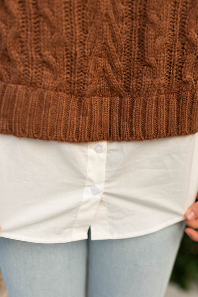 Close up of faux button up white shirt on a camel sweater