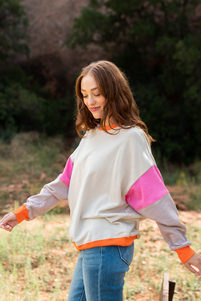 Side view of a stone pink pullover