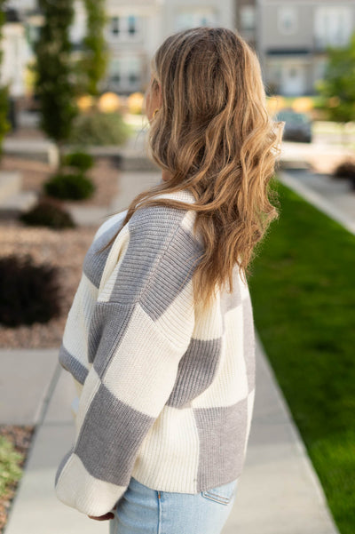 Side view of a grey sweater