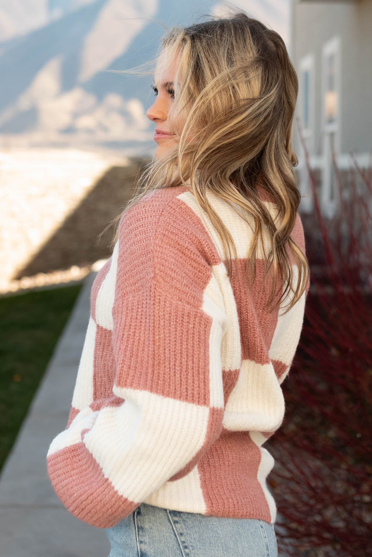 Side view of a marsala sweater
