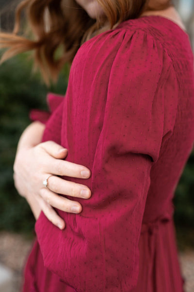 Sleeve view of a deep red dress