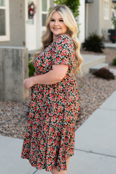 Side view of a plus size black dress with flowers