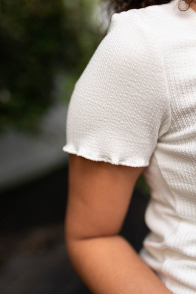 Close up of the sleeve on the off white top