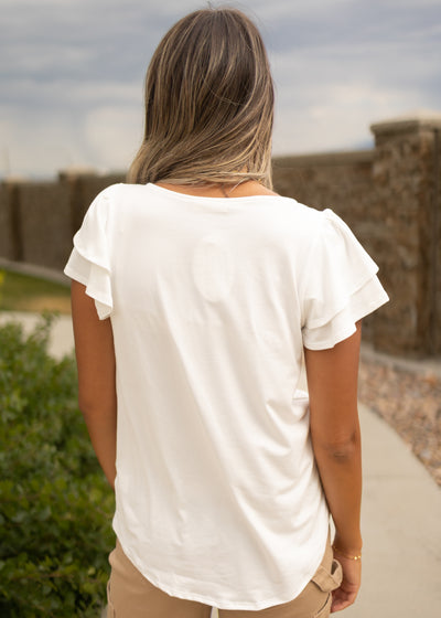Back view of a white top with ruffle sleeves