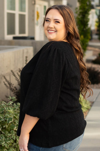 Side view of a plus size black top