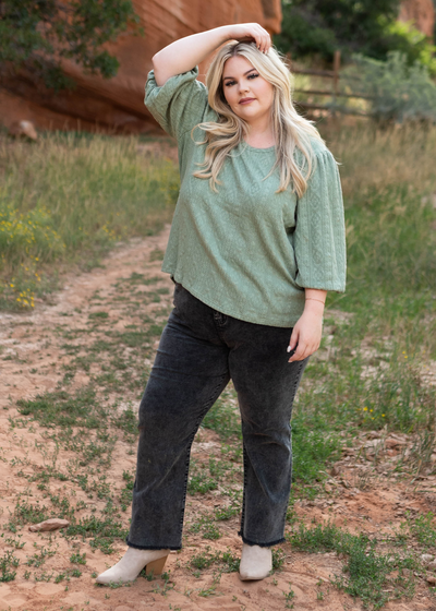 Patterned fabric of a plus size sage green top