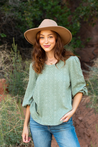 Front view of a textured fabric sage top with short sleeves