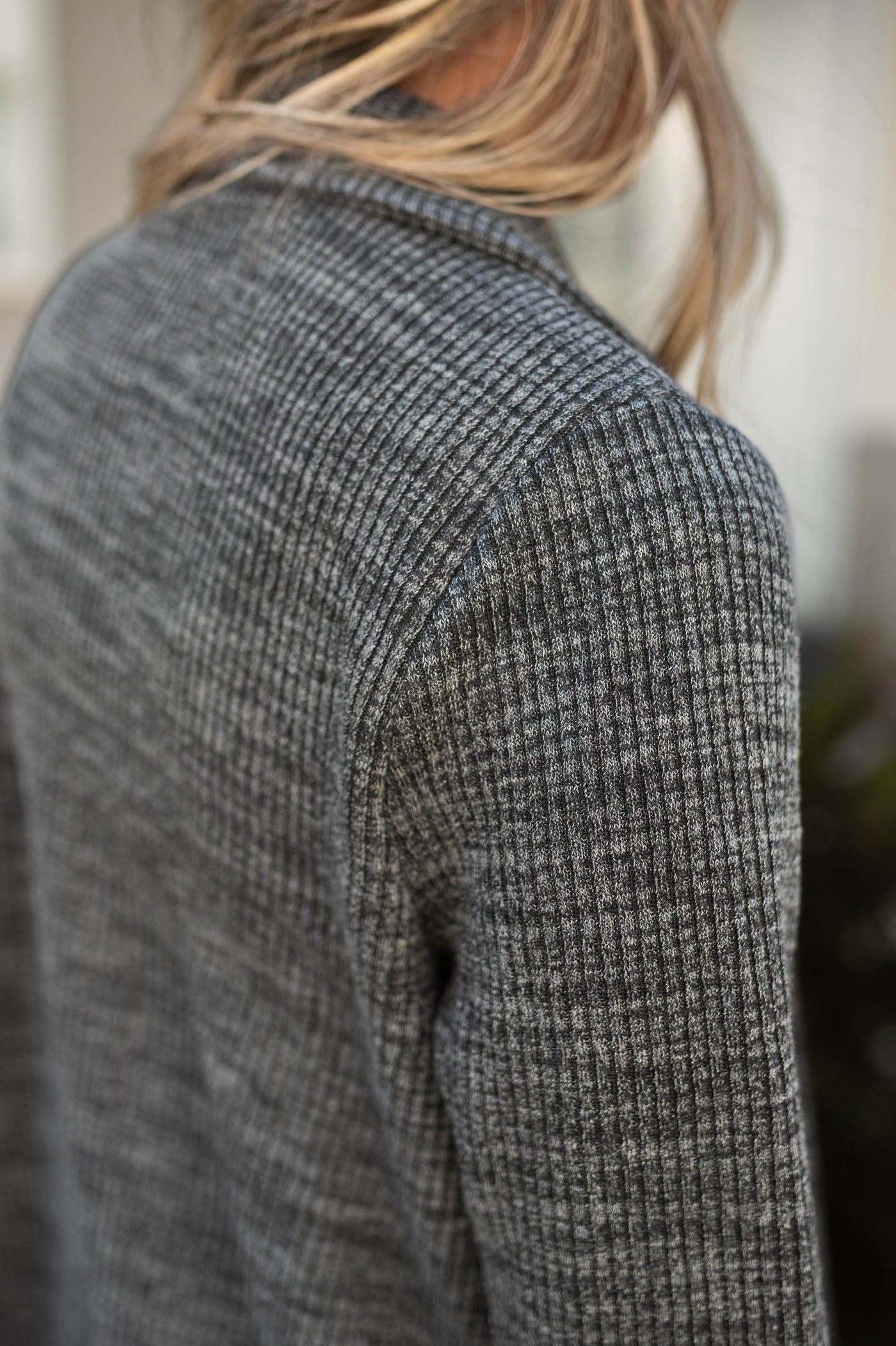 Sleeve view of a charcoal blazer