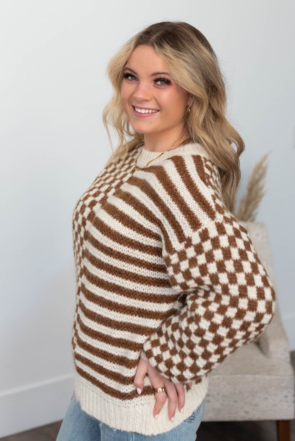 Side view of the brown checkered sweater