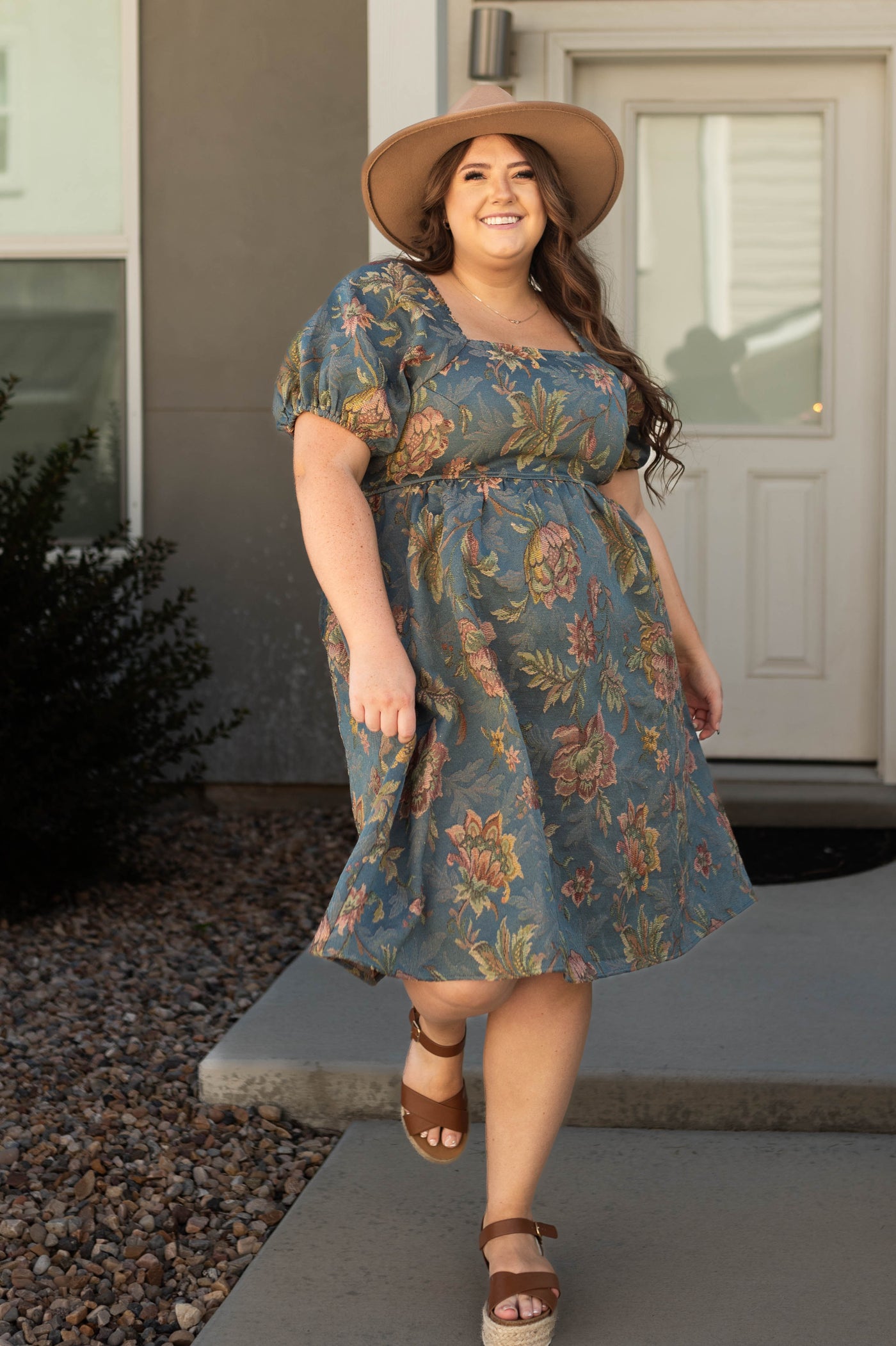 Knee length teal floral dress with short sleeves and a square neck
