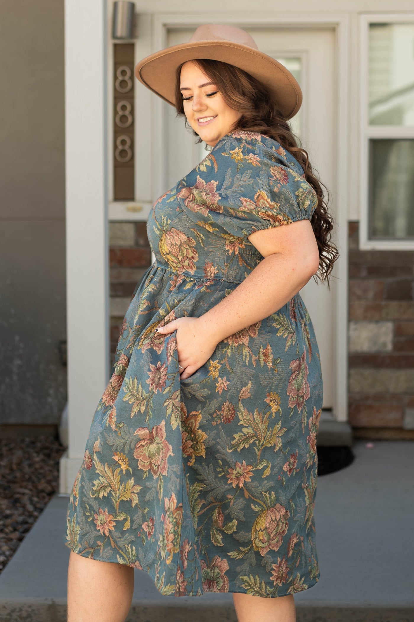 Side view of a plus size teal floral dress