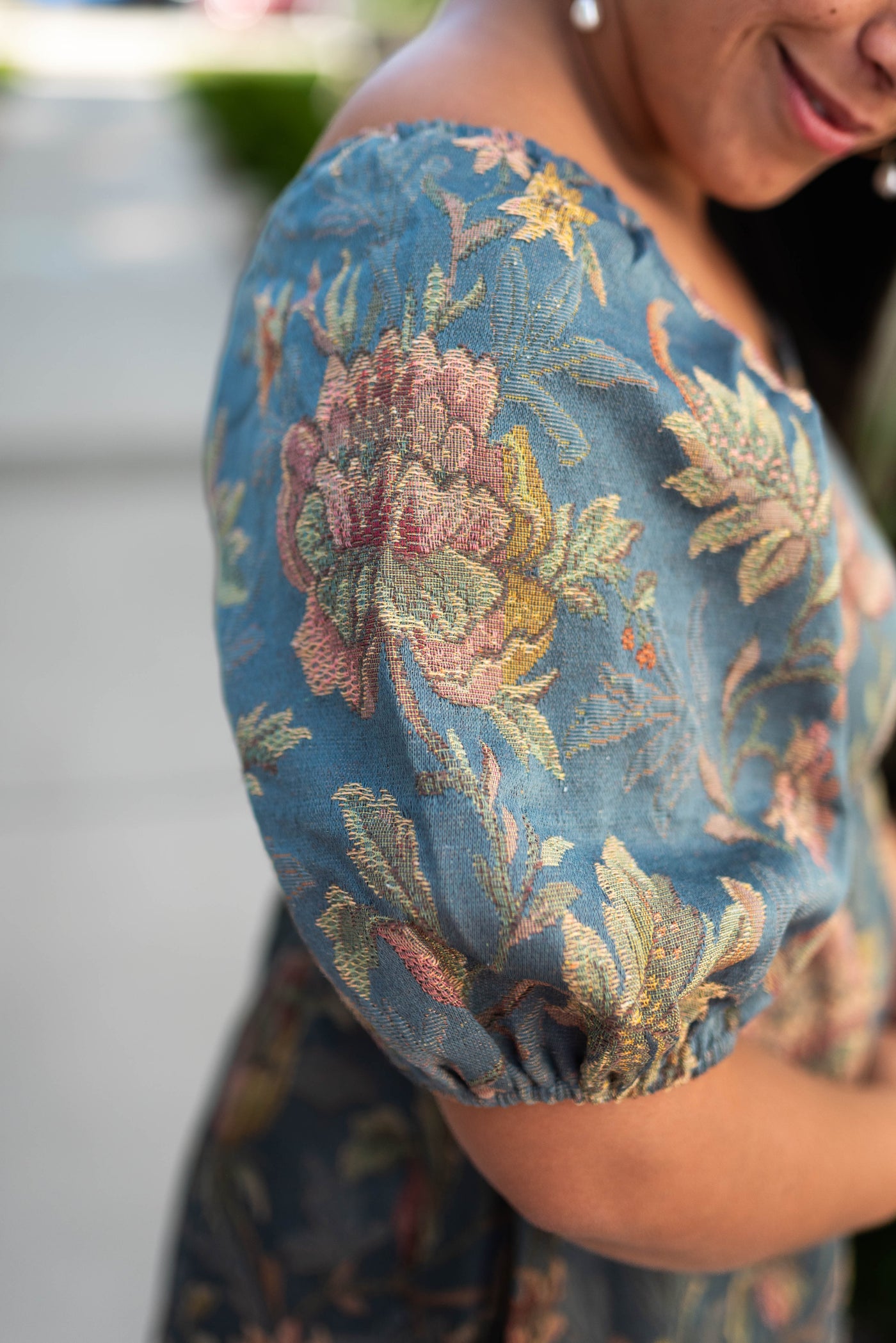Sleeve of a teal floral dress