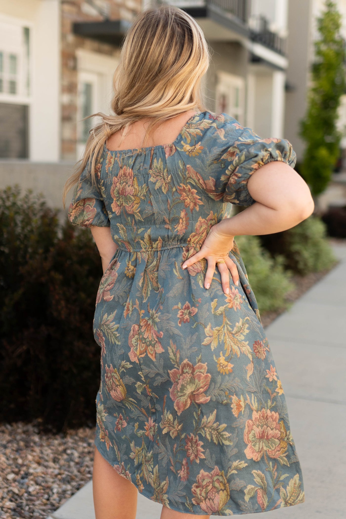Back view of a teal floral dress